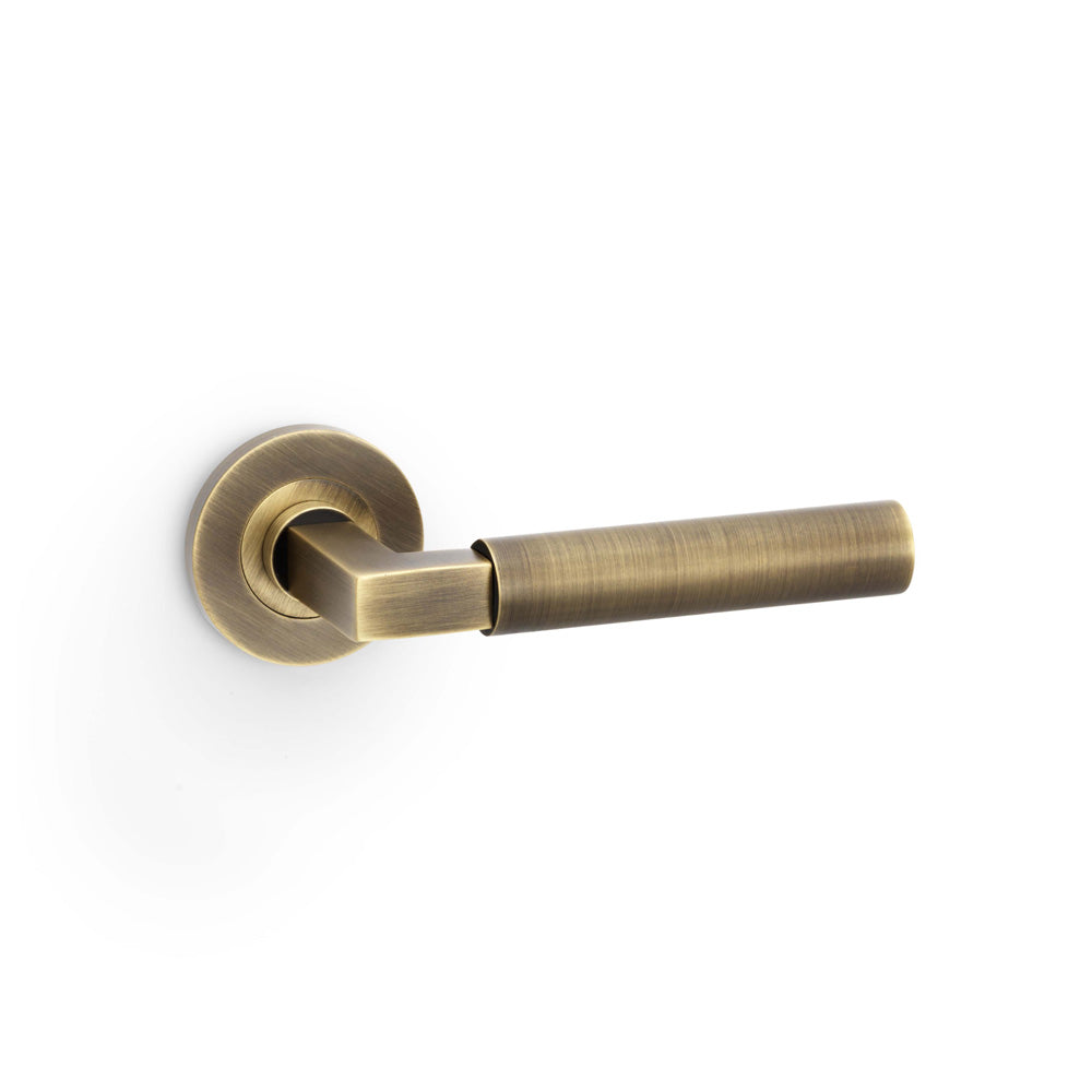 Hurricane Lever Door Handle on Rose – Antique Brass