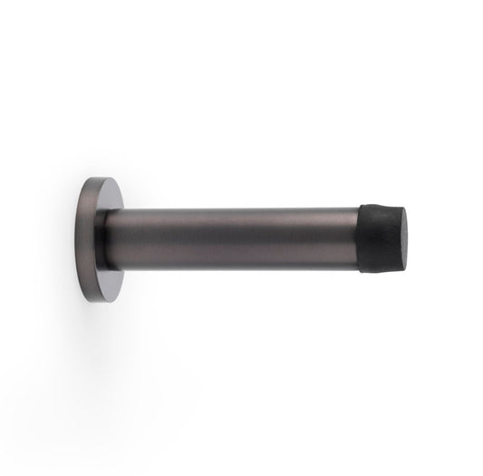 Dark bronze Cylinder Projection Door Stop on Rose by Alexander & Wilks, showcasing its traditional cylindrical design and high-quality solid brass construction.