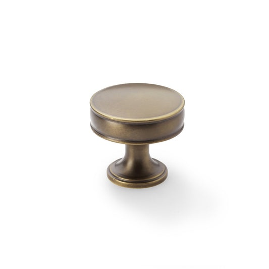 Antique brass 38mm Alexander & Wilks Lynd cupboard knob featuring dual ring detailing and fluted stem.