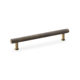 Alexander & Wilks knurled T-bar cupboard pull handle in antique brass, 160mm centres, featuring industrial design and solid brass construction