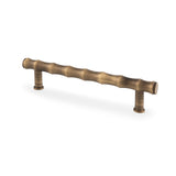 Bamboo T-bar Cupboard Pull Handle in Antique Brass finish, 128mm centre dimensions, ergonomic and durable design by Alexander & Wilks