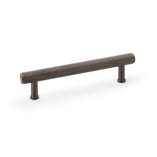 Alexander & Wilks Crispin Reeded T-bar Cupboard Pull Handle in Dark Bronze PVD, 128mm, showing full-length reeded design and solid brass construction.