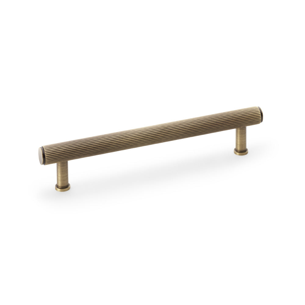 Alexander & Wilks Crispin Reeded T-bar Cupboard Pull Handle in Antique Brass, 160mm on display