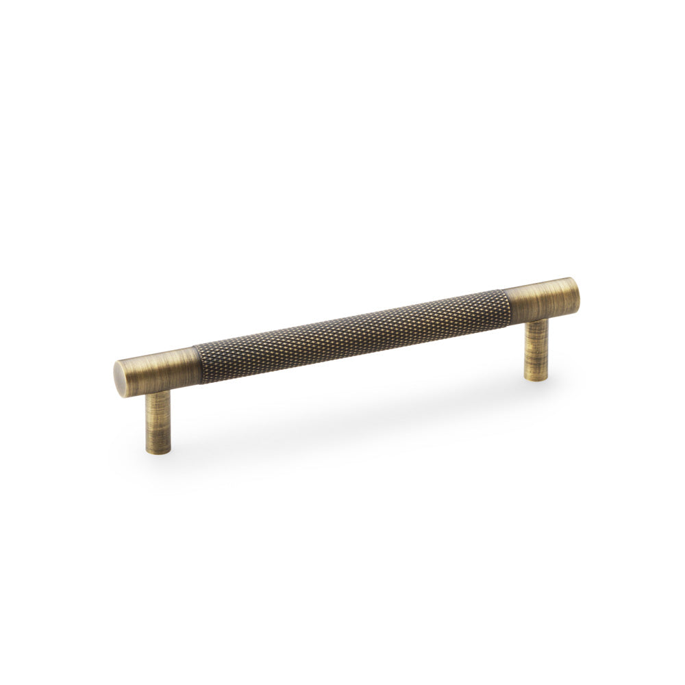 "Antique Brass Knurled T-Bar Cupboard Handle by Alexander & Wilks with diamond texture and classic finish, ideal for enhancing interior spaces"