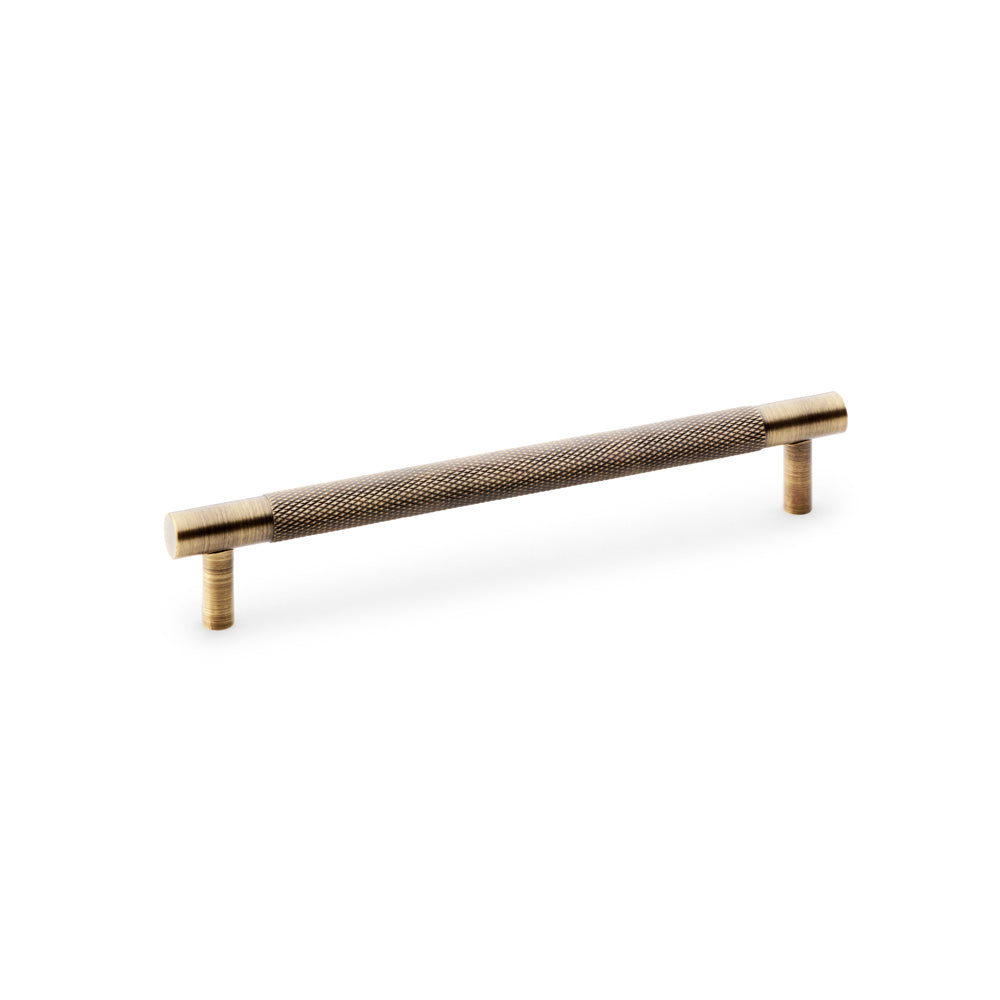 Knurled T-Bar Cupboard Handle by Alexander & Wilks in Antique Brass, featuring diamond knurled texture for improved grip and classical design, perfect for kitchens and bathrooms.