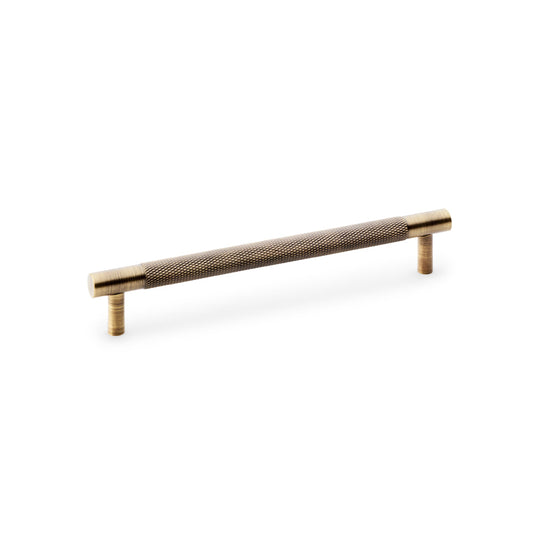 Knurled T-Bar Cupboard Handle by Alexander & Wilks in Antique Brass, featuring diamond knurled texture for improved grip and classical design, perfect for kitchens and bathrooms.
