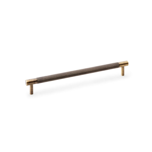 "Antique Brass Knurled T-Bar Cupboard Handle by Alexander & Wilks, 224mm centre spacing, ideal for enhancing both modern and traditional interiors"