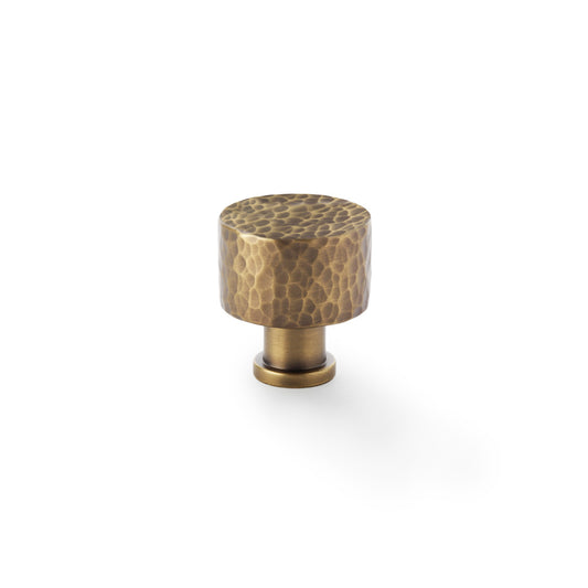 "Alexander and Wilks Leila hammered cupboard knob in antique brass 30mm, showing distinctive textured design and solid brass material"