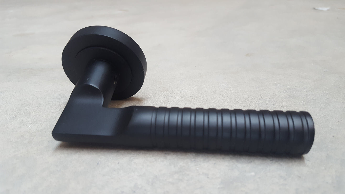 Matt Black Engineered Lever Door Handles On Round Rose