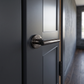 Black Nickel 'T-Bar' Design Door Handles on Round Rose - SPI-SB1304BN - fitted on a door