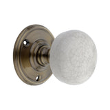 Crackled Porcelain Mortice Door Knob in Antique Brass, 60mm diameter, part of the Spira Brass range, showcasing timeless elegance and modern durability.